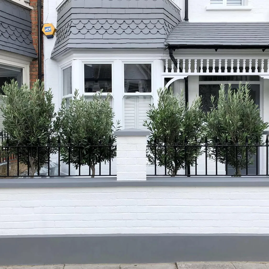 white garden walls with tress