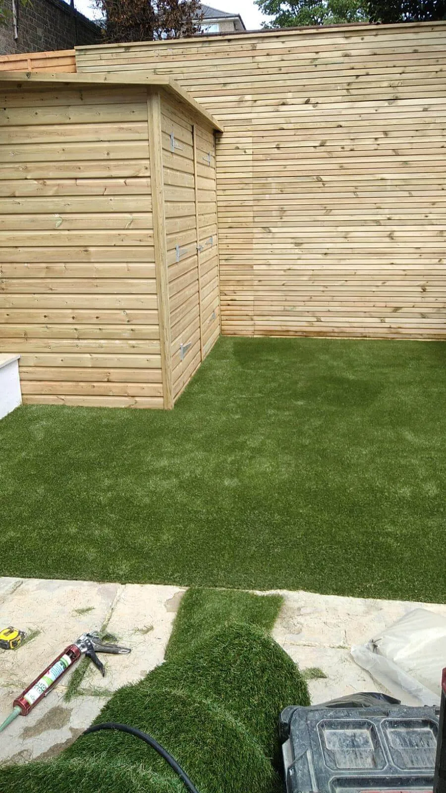 new artificial grass under shed